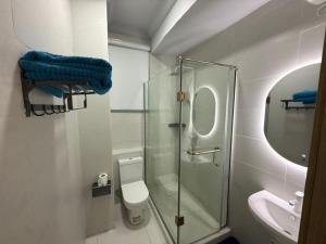 a bathroom with a shower and a toilet and a sink at Pc Luxury 1 bedroom with pool in Lagos +8 photos