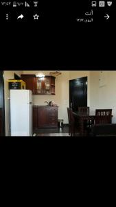 a kitchen with a white refrigerator and a table with chairs at Chalet in sharm el shekh in Sharm El Sheikh +14 photos