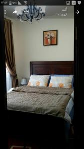 a bedroom with a bed and a picture on the wall at Chalet in sharm el shekh in Sharm El Sheikh