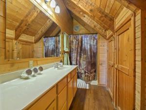a bathroom with a sink and a mirror at The Nut House in Sevierville +58 photos