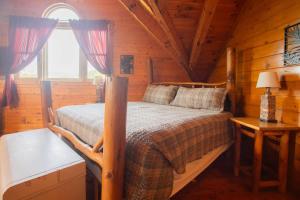 a bedroom with a bed in a log cabin at The Nut House in Sevierville
