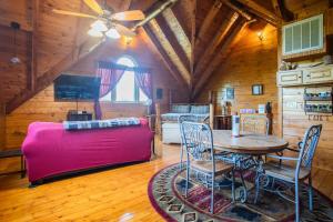 a living room with a pink couch and a table at The Nut House in Sevierville