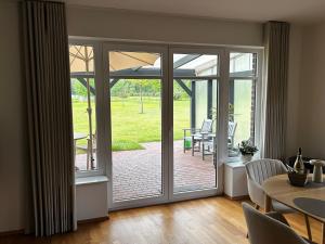 an open door to a patio with a table and chairs at Ferienhaus Weidblick in Westerstede