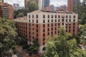 a large brick building in the middle of a city at Hotel Park10 in Medellín