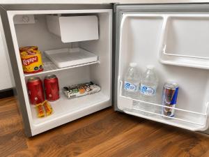 an open refrigerator filled with drinks and water bottles at Alojamiento en Paine cerca Monticello in Hijuela Larga