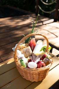a basket filled with different types of food on a table at Sandomierskie Szepty Lasu - Glamping Sandomierz in Gałkowice +45 photos