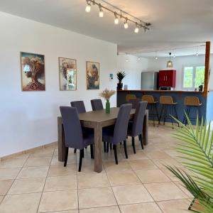 a dining room with a table and chairs at Villa Énalia in Barjac