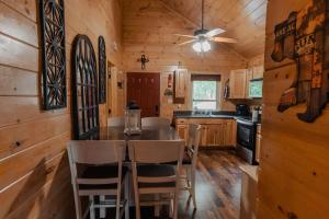 a kitchen with a table and chairs in a cabin at The Burrows in Sevierville