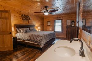 a bedroom with a bed and a ceiling fan at The Burrows in Sevierville