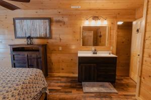 a bathroom with a sink in a wooden cabin at The Burrows in Sevierville +82 photos