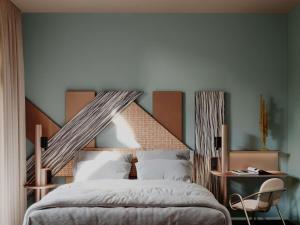 a bedroom with a large bed with a wooden headboard at TRIBE Strasbourg Centre Gare in Strasbourg +36 photos