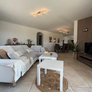 a living room with a couch and a table at Villa Énalia in Barjac