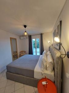 a bedroom with a large bed and a window at Margarita's Home in Steniaí
