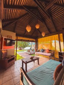 a room with a bed and a table and a tv at Villa Mitirapa in Tohautu