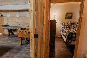 a bedroom with a bed and a table in a room at The Rustic Charm in Sevierville