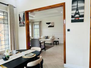 a living room with a dining table and a mirror at Hazina Homes in Boma la Ngombe