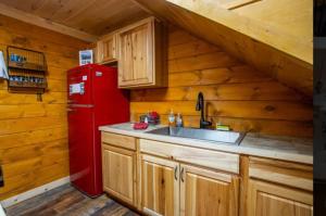 a kitchen with a red refrigerator and a sink at The Rustic Charm in Sevierville +162 photos