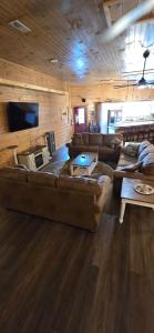 a large living room with couches and a tv at The Rustic Charm in Sevierville