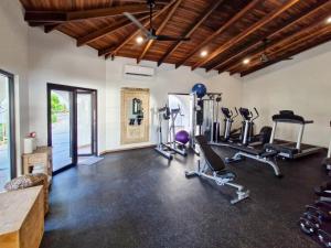 a gym with treadmills and cardio equipment in a room at Reunion Wellness Resort & Retreats in Playa Danta