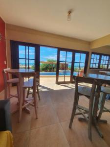 a dining room with a view of the ocean at Villa Maze Suites - Canoa Quebrada in Aracati