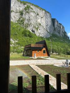 a building in front of a mountain at Komarnica Forest Owl 1 in Šavnik