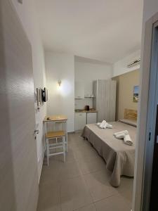 a small bedroom with a bed and a table at B&B la Quiete in Leverano
