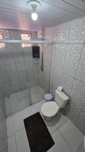 a white bathroom with a toilet and a shower at Hotel Pousada Farol da Praia in São Luís +45 photos
