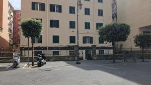 two motorcycles parked in front of a large building at Mare Apartment in Nocera Inferiore