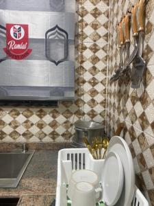a kitchen counter with a sink and a toilet at Ramlat Service Apartment in Ilorin +13 photos