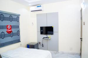 a hospital room with a bed and a tv at Ramlat Service Apartment in Ilorin