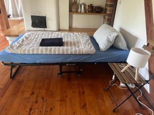 a bed on a bed frame in a room at SAAL am Pfarrhaus in Penzlin
