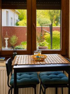 a table with a bowl on it in front of a window at Studio apartman Hinko in Đakovo