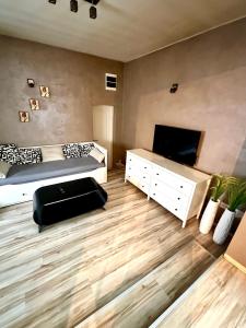 a bedroom with two beds and a flat screen tv at YAMM Pool House in Mali Požarevac