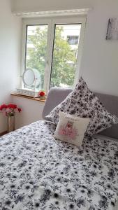 a black and white bed with a pillow on it at Messe-Badische SBB- grosse Wohnung in Basel