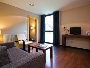 a living room with a couch and a table at Balneario Elgorriaga in Elgorriaga