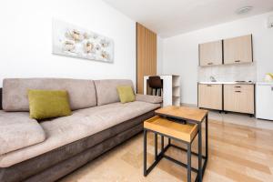 a living room with a couch and a table at Bed and Breakfast Ivona in Baška Voda