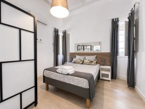 a bedroom with a bed and a large window at Casa da Aida - Fuzeta in Fuzeta +58 photos