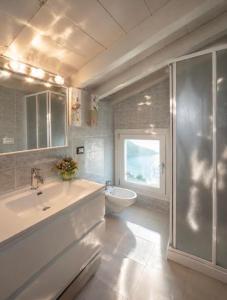 a bathroom with a sink and a toilet at Lake View 49 in Sale Marasino +46 photos