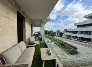 a balcony with a couch and a table on a building at Andrea Apartman in Alsóörs