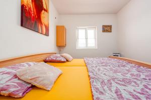 a bedroom with a bed with two pillows on it at Apartments Ivan in Vir