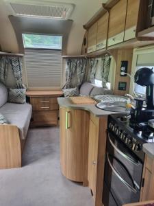 a kitchen in an rv with a sink and a stove at Kościelnik Camp in Kościelnik