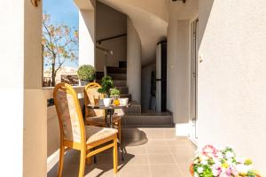 a balcony with a table and chairs and stairs at Apartments Ivan in Vir