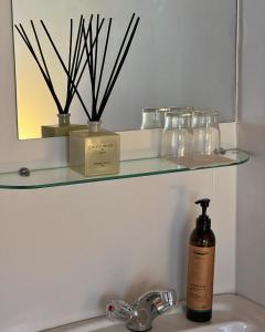 a bathroom sink with a bottle of soap and a mirror at Engimyri Lodge in Akureyri +44 photos