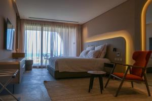 a bedroom with a bed and a desk and a chair at The Red - a GiGi Residence in Mājid Abū Zayd +15 photos