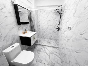 a white bathroom with a toilet and a sink at Studio ANA Saturn 1 in Saturn +14 photos