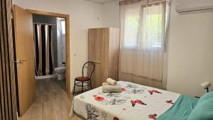 a bedroom with a bed and a bathroom with a window at Golden Tower Rooms - auto check-in in Gandía +14 photos
