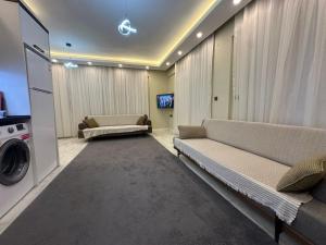 a living room with two couches and a tv at Alas Garden City Apartment Fethiye in Fethiye