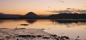 a body of water with a mountain in the background at Alojamiento con encanto in Santoña +8 photos