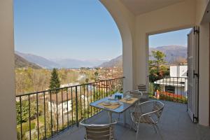 a patio with a table and chairs on a balcony at Marenca Residence in Cannobio