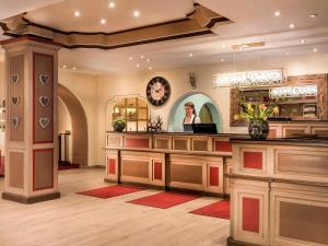 a hair salon with a woman in a mirror at Sunday Hotel Garmisch Partenkirchen in Garmisch-Partenkirchen +79 photos